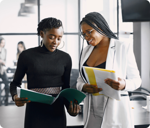 two woman exchanging notes for skills development