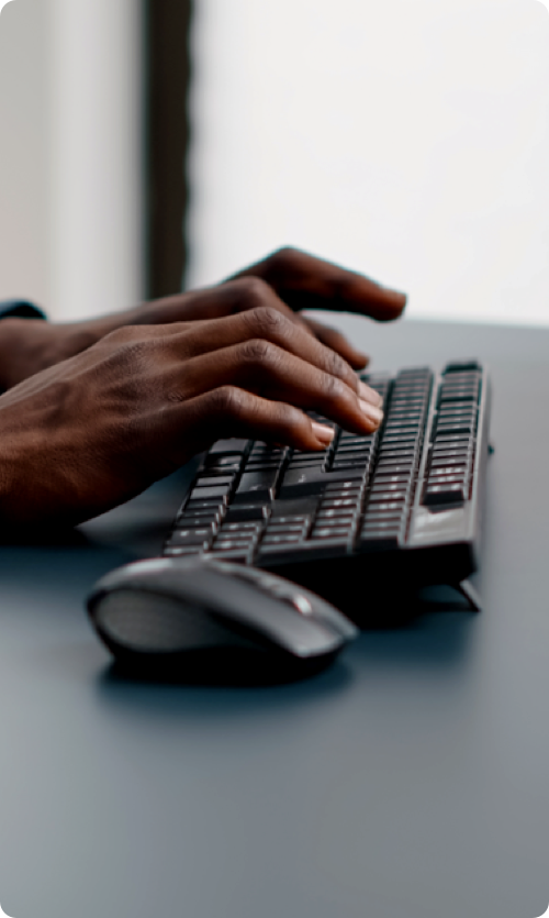 man typing on keyboard