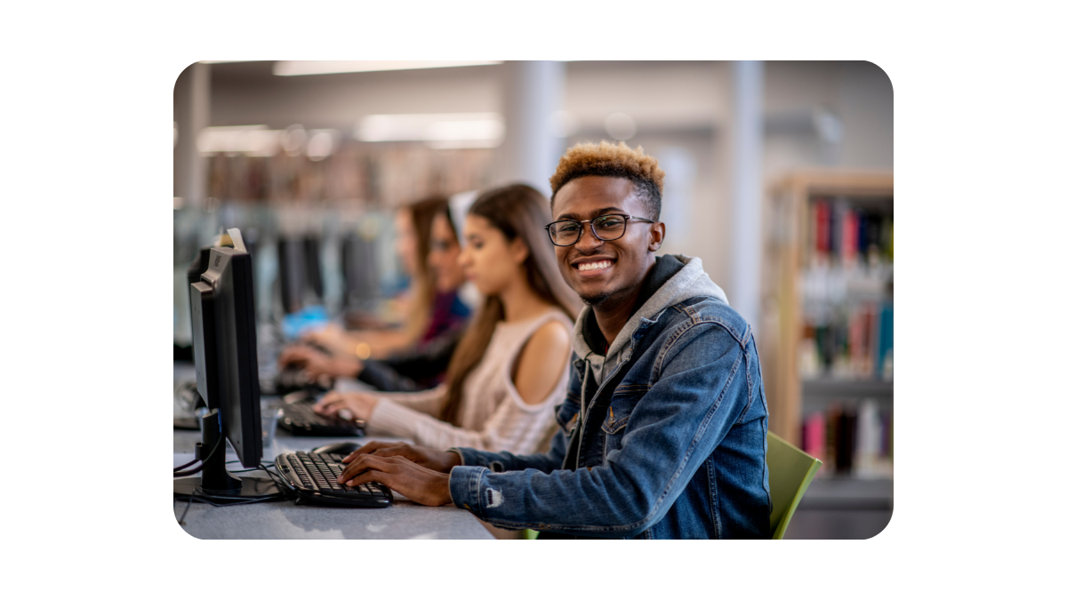 Black man smiling confidently in a training room, representing successful Learner Recruitment. Black man smiling confidently in a training room, representing successful Learner Recruitment.